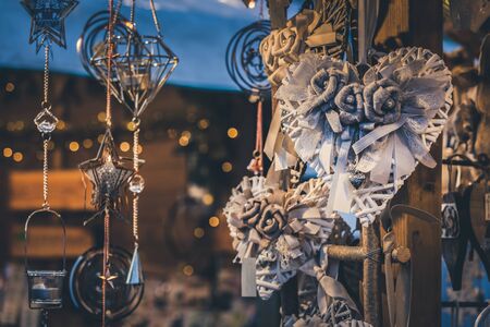 Illuminated Christmas fair kiosk with handcrafted xmas decorations, mercatino di Natale in Trentoの写真素材