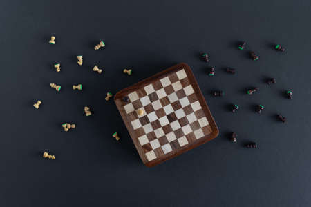 Souvenir wooden chess on a dark background. Intellectual board game.