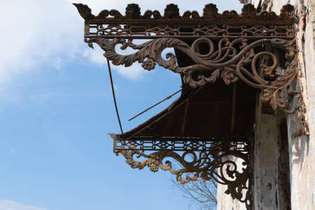 Cast antique metal brackets. Decorative architectural elements. Old building. Horizontal photo. Close-up.の写真素材