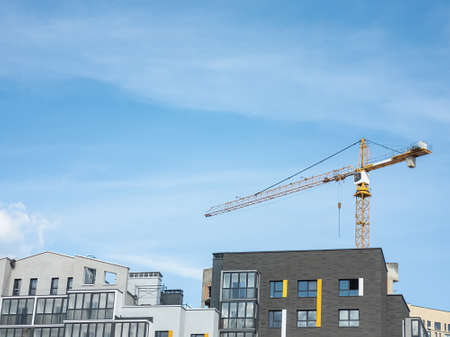 Tower cranes in the construction of high-rise buildings. Construction concept. Horizontal photo.