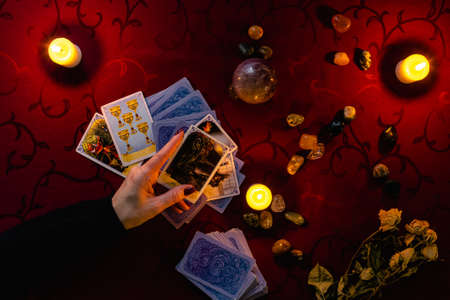 Minsk, Belarus - November 2021: the fortuneteller holds the Death tarot card in his hand. Photo of the layout on the Tarot cards.のeditorial素材
