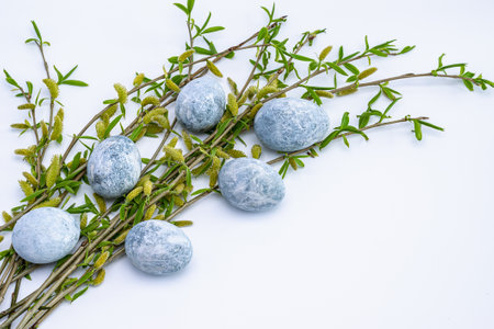 Marble Easter eggs and willow twigs on a white background. easter greeting card. horizontal photo.