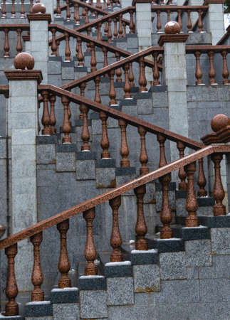 Staircase made of marble and granite. City architecture. Geometry of architectural elements. Vertical photo.の写真素材