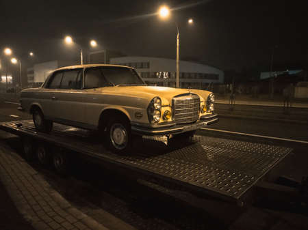 Minsk, Belarus-March 2022: Mercedes-Benz retro car standing on a gun carriage. Night photo in the light of lanterns. horizontal photo.のeditorial素材