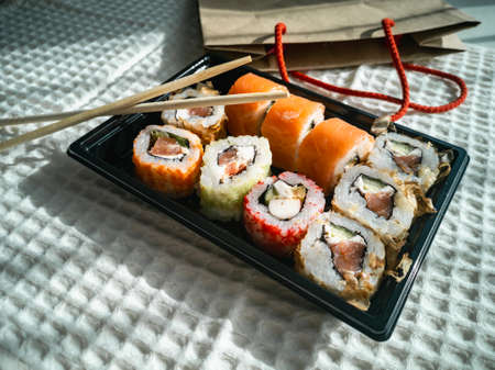 Online ordering and food delivery. Sushi is a Japanese dish.の写真素材