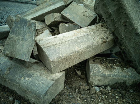 A stack of paving slabs for sidewalk construction.