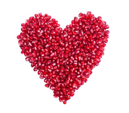 garnet, grains, pomegranate seeds in the form of heartの写真素材