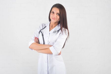 Portrait of woman doctor at hospital corridor, holding tablet computer, looking at camera, smilingの写真素材
