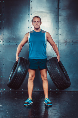 Sportsmen. fit male trainer man keeps the car tires, concept crossfit fitness workout strenght power.の写真素材