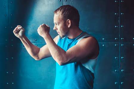 Athlete, sportsman muscular man in a position of readiness, sport, wrestling.の写真素材