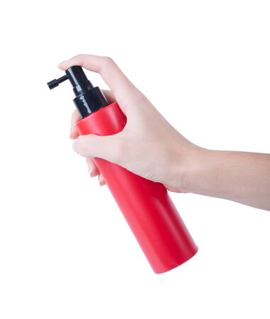 hair spray red bottle isolated on white background, pressing the hand of manの写真素材