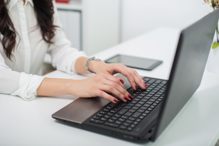 women working with laptop, view of hands on notebook , business person at workplaceの写真素材