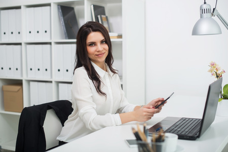 Young business woman with notebook in the office, workplace.の写真素材