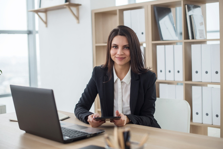 Young business woman with notebook in the office, workplace.の写真素材