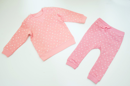 Clothes for newborn girl on white background.の写真素材