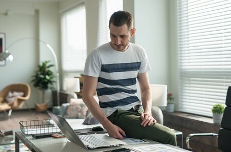 Young business man working with laptop at his desk in the office.の写真素材