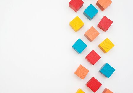 Scattered colored wooden children s designer on a white background.の写真素材