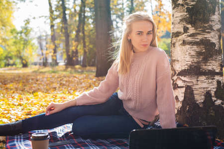 Young woman working with laptop outdoors.の写真素材