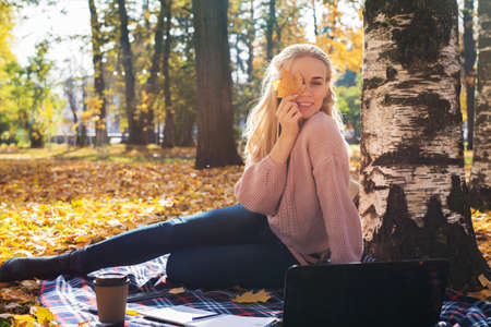 Young woman working with laptop outdoors.の写真素材