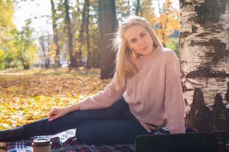 Young woman working with laptop outdoors.の写真素材