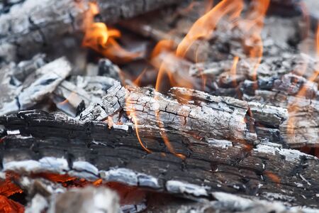 burning up white hot coals and the bright red flames of a fire