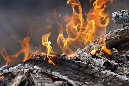 burning up white hot coals and the bright red flames of a fire