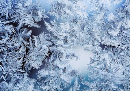 Beautiful frosty pattern made of transparent swirls and crystalsの写真素材