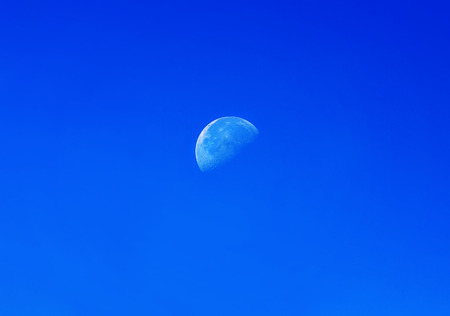 half white moon on blue sky dayの写真素材
