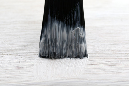 brush paint a wooden floor white color