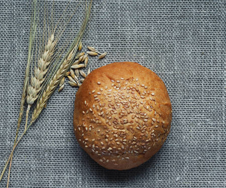 still life of bread and wheat ears on linenの写真素材