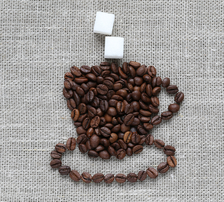  figure of the Cup is lined with grains of roasted coffee with two sugarsの写真素材