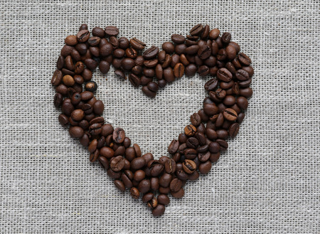heart made of coffee beans on a linen fabricの写真素材