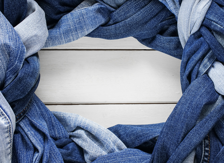 frame stylish plaits and braids woven and twisted from a variety of blue jeans on white backgroundの写真素材