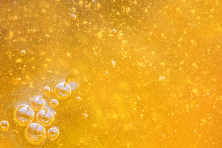  tasty liquid background of fresh Golden honey with bubbles glistening in the sun.の写真素材
