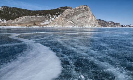 blue ice of lake Baikal, the rock and the little houses