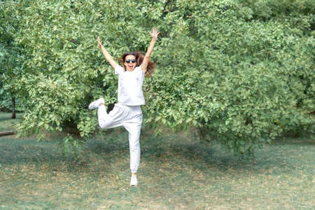 Emotional brunette girl rejoices jumps up.