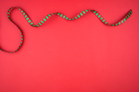 red background with Christmas ribbon.の写真素材