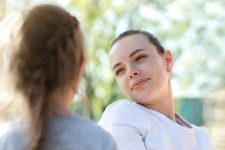 mother looking at daughter with love and tenderness.の写真素材