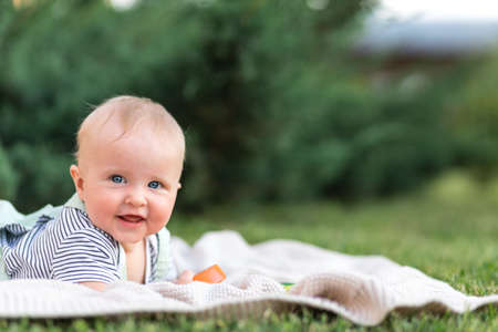 Cute Baby up to a year in the summer in nature, close-up, copy space. Nature background.の写真素材