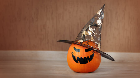 One pumpkin with an ominous grimace with a witchs hat stands inside the room.の写真素材