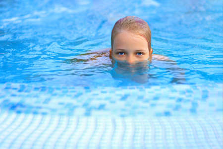girl with beautiful eyes in the pool.の写真素材