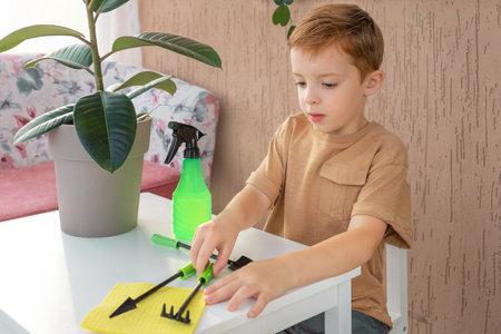 child fascinated by plant care, young gardener.の写真素材