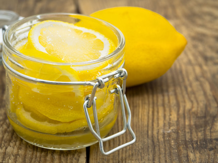 Lemon slice wirh sugar in jar on wooden backgroundの写真素材