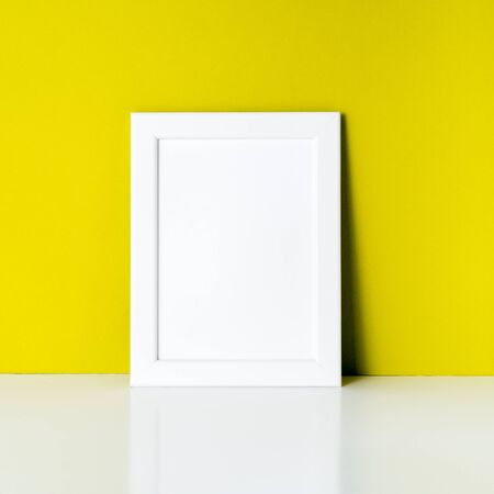 mock up frame on bright yellow paper wallの写真素材
