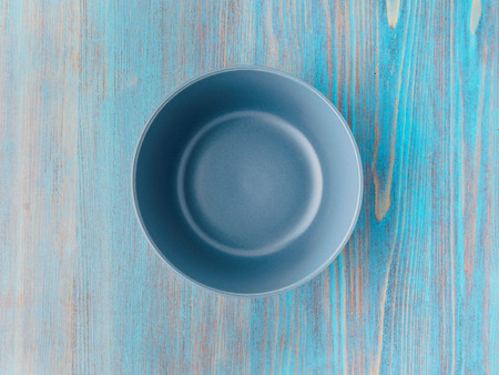 empty ceramic bowl for soup on the old wood turquoise tableの写真素材