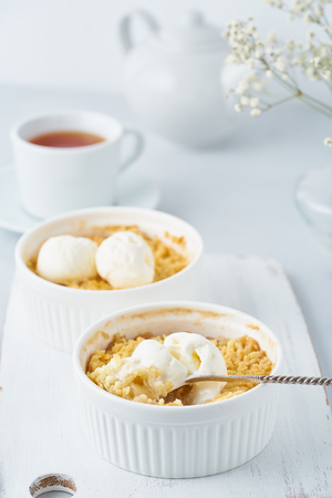 Apple crumble, spoon with ice cream, streusel.  Morning breakfast.の写真素材