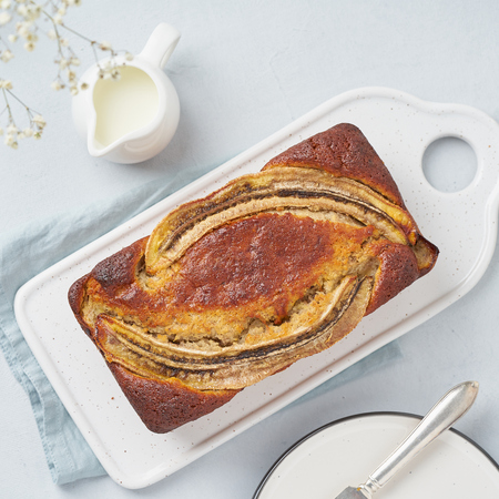 Whole Banana bread. Cake with banana and walnut. Traditional american cuisine. Top view, close upの写真素材