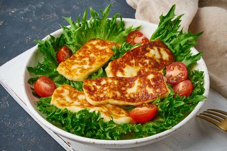 vegan salad with fried halloumi and tomatoes, closeup, ketogenic dietの写真素材