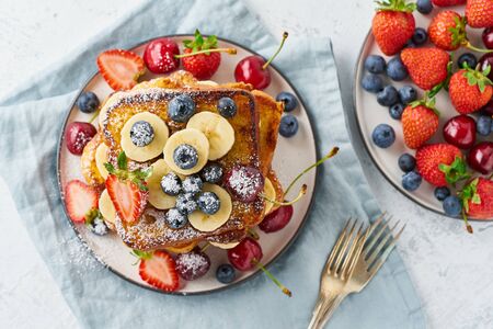 healthy french toasts with berries and banana, confort stack of toasts, homemade briocheの写真素材