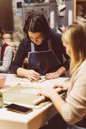 Woman making ceramic pottery on workshop. Concept for woman in freelance, business. Handcraftの写真素材